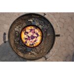 Postre de bayas horneado en una sartén de hierro fundido sobre la barbacoa de carbón Weber Master-Touch de 67 cm.