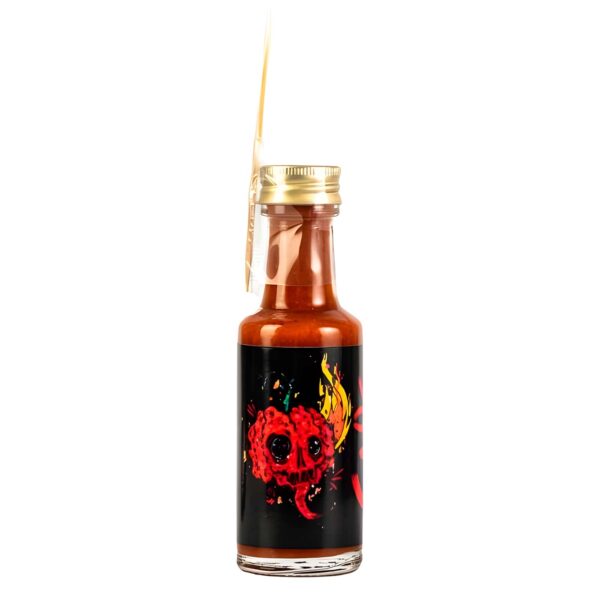 Botella de Salsa Caos de 20 ml con etiqueta de diseño colorido que muestra un dibujo de un cráneo rojo en llamas, lo que sugiere su intensidad extrema.