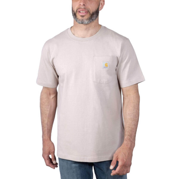 Hombre con camiseta Carhartt K87 de manga corta en color visón, con bolsillo lateral y logo de la marca, combinada con jeans