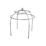 OFYR black steel cage with food hung over a barbecue, surrounded by tables with cooking utensils at an outdoor event with lawn.