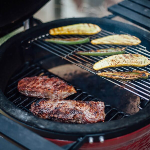 Carne y verduras asadas en parrilla media luna Kamado Joe Classic Joe.