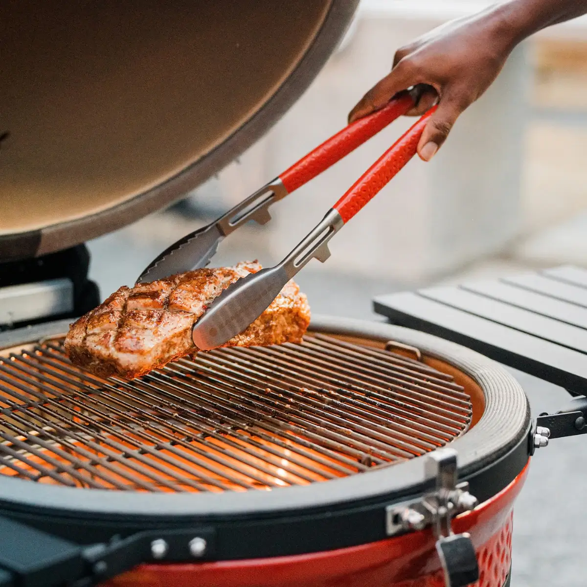 Grilled salmon fillet being removed with Kamado Joe Krafted tongs