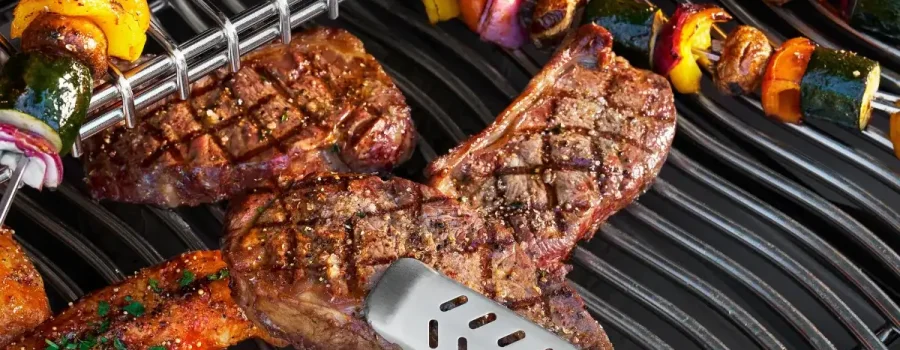 A close-up of the Napoleon Prestige PRO 500 VX searing meat in the SIZZLE ZONE with one hand using tongs.